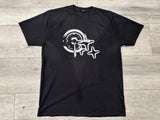 Black t-shirt with white graphic design on a wooden surface